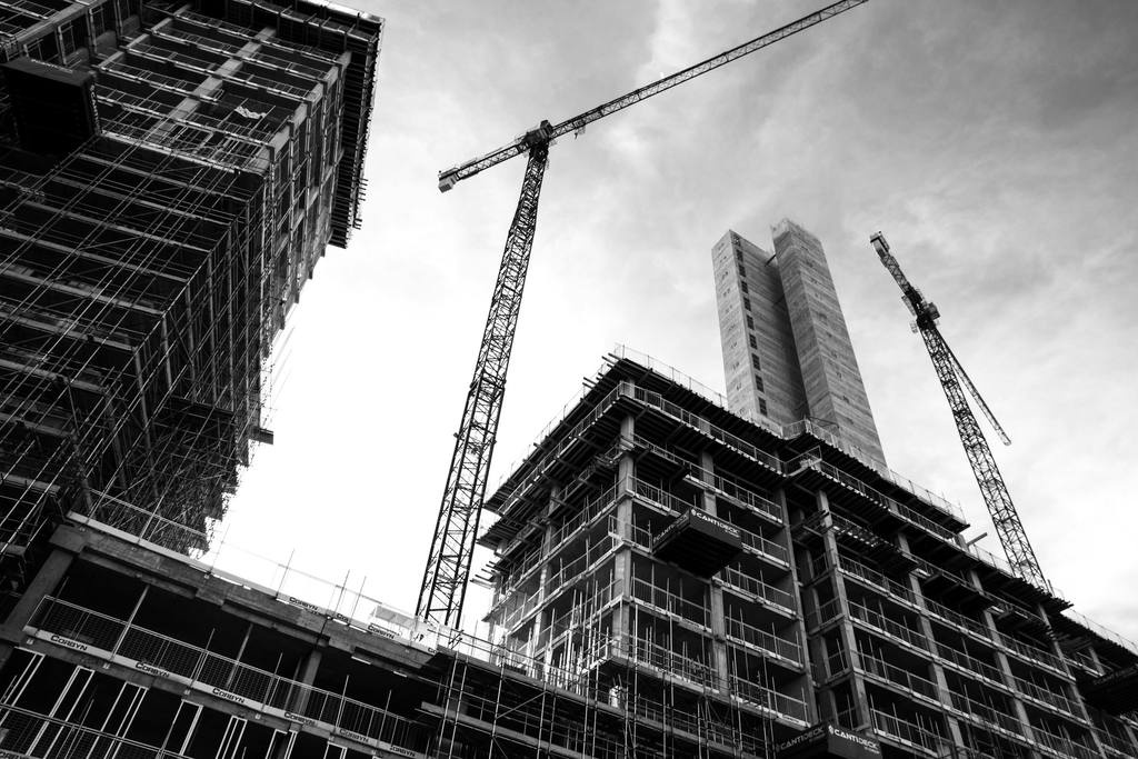 Scaffold access structure shown alongside contact details for Sure Thing Scaffolding Limited.