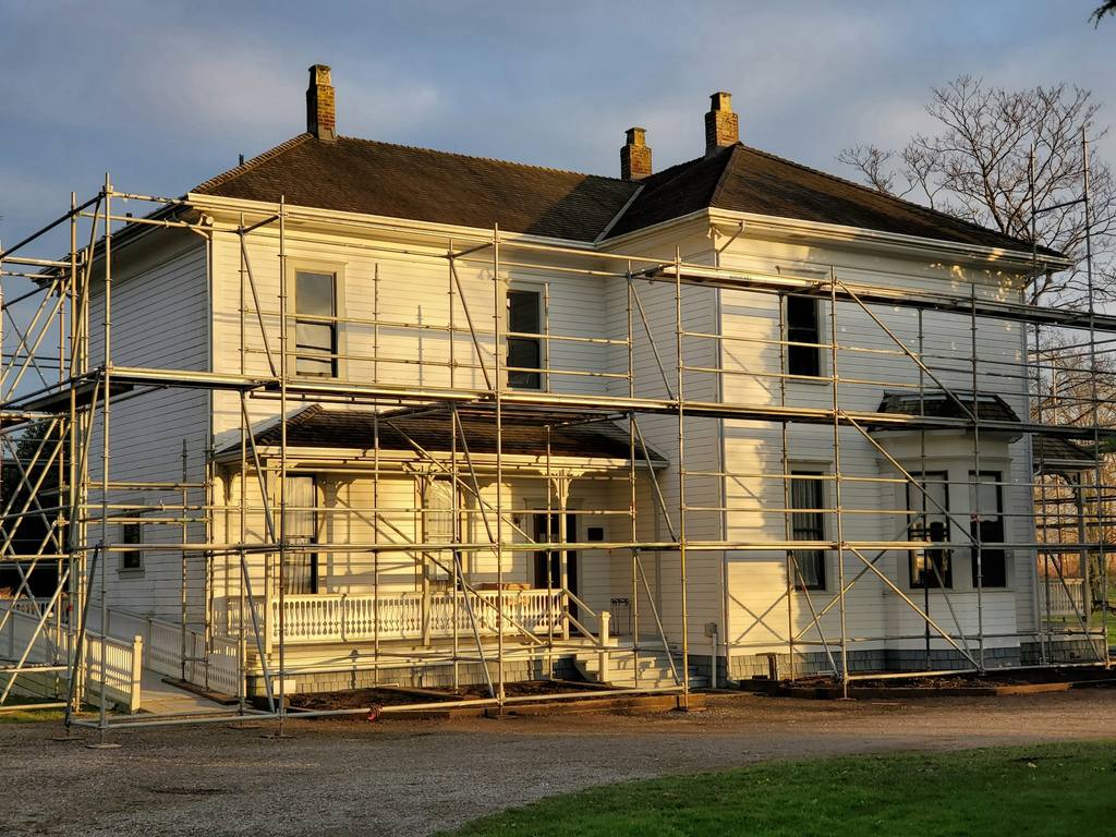 Temporary scaffold access supporting exterior renovation work on a residential property.